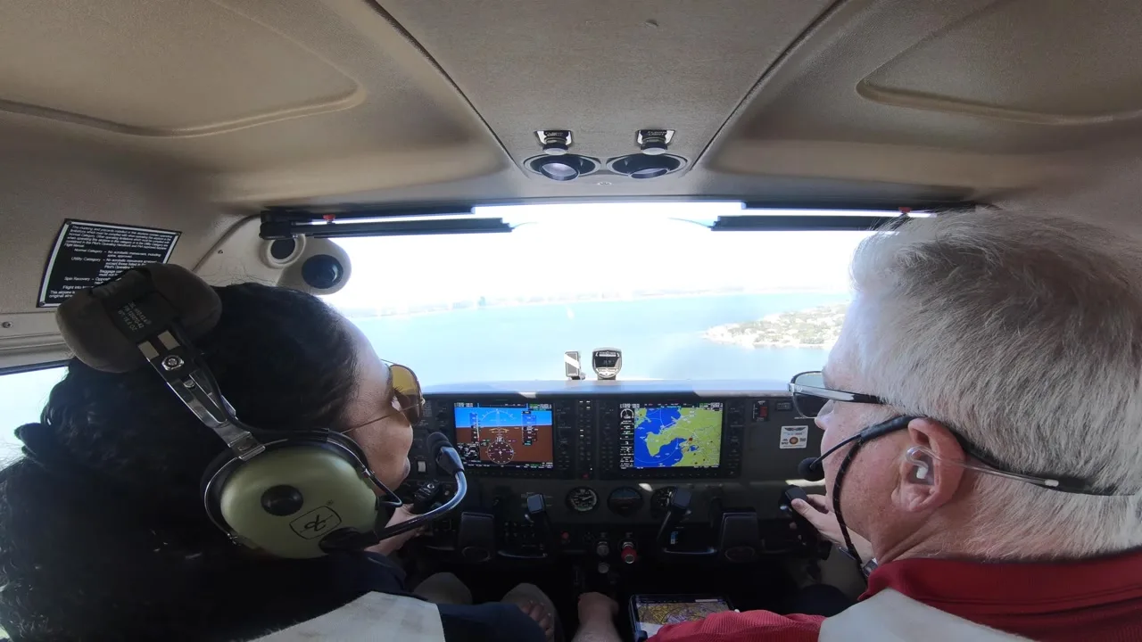 Flight instructor and student in the cockpit over Tampa Bay