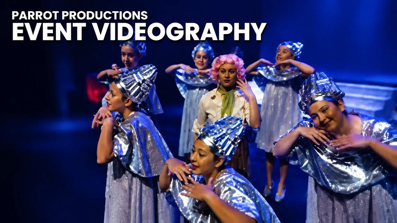 Parrot Productions event videography thumbnail: dancers in silver costumes surround a central performer on a blue-lit stage